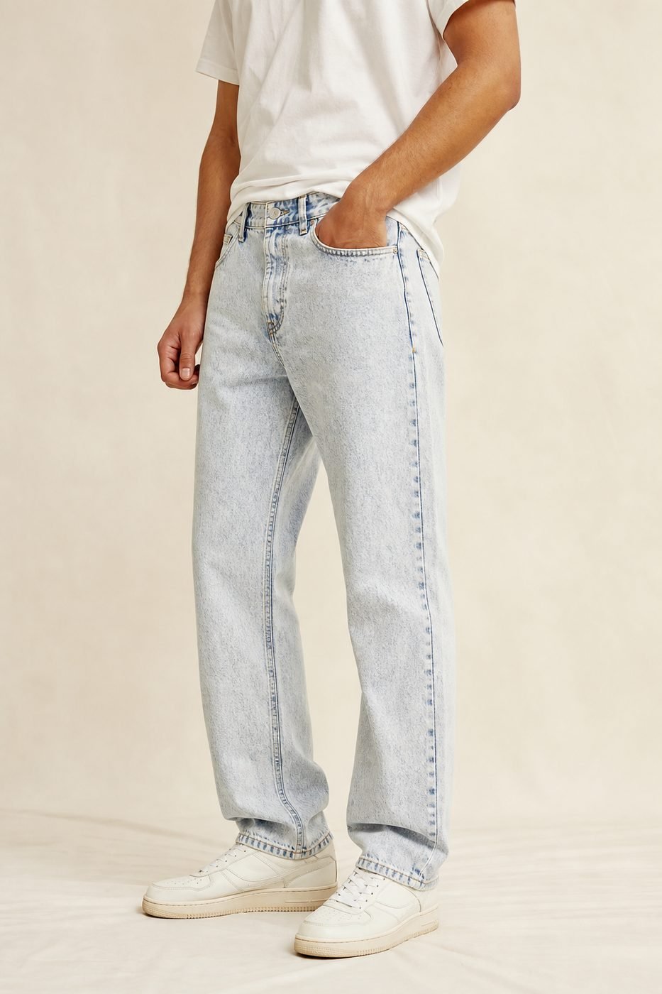 Man wearing light acid wash jeans